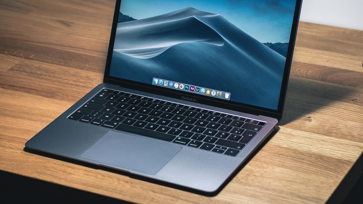 An open laptop on a wooden desk